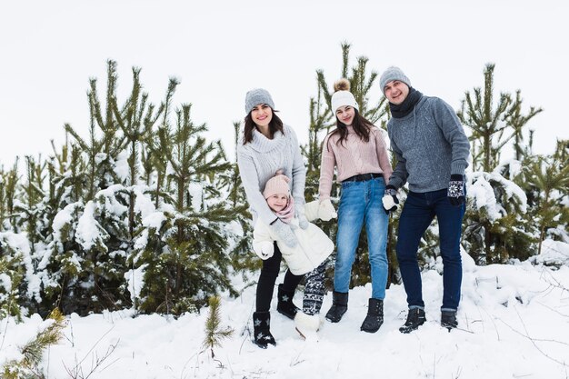 Family posing near spruces