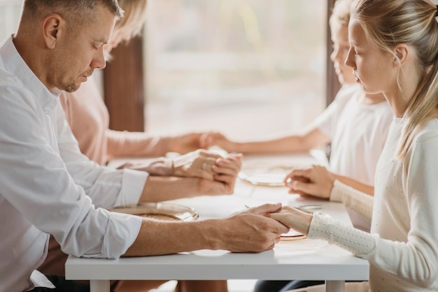 Family praying before eating