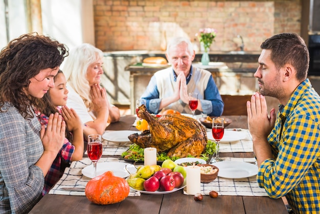 Family praying before meals