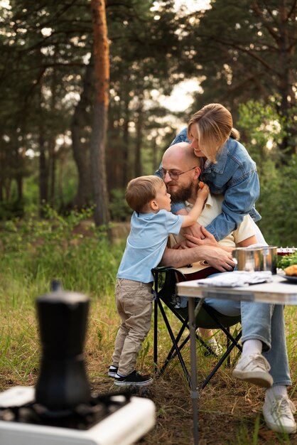 Family preparing dinner while in camping