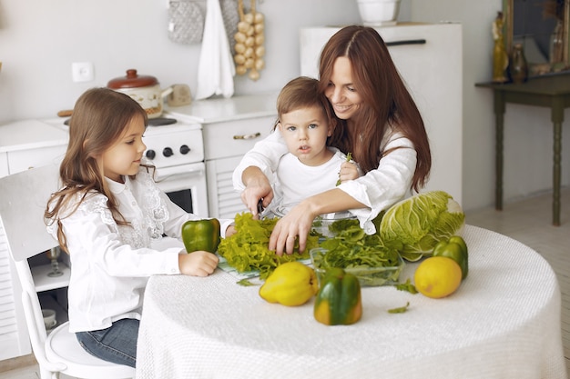 Free photo family preparing a salad in a kitchen