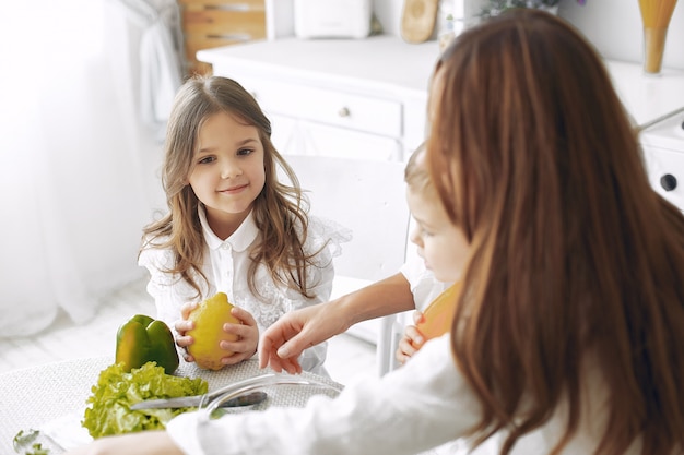 Family preparing a salad in a kitchen