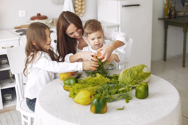 Family preparing a salad in a kitchen