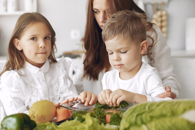 Family preparing a salad in a kitchen