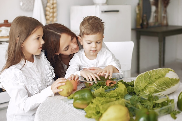 Free photo family preparing a salad in a kitchen