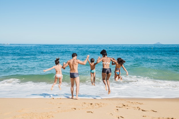 Family running into the water