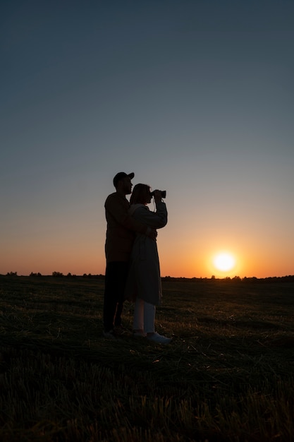 Free photo family silhouettes having fun at sunset full shot