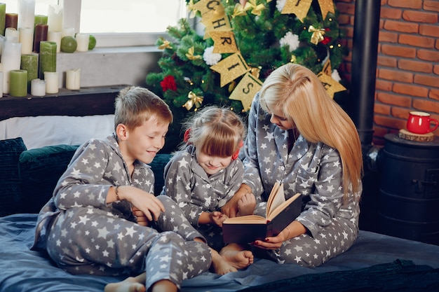 Free photo family sitting on a bed