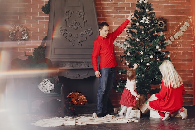 Family sitting at home near christmas tree