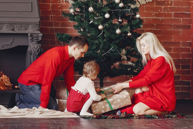 Family sitting at home near christmas tree