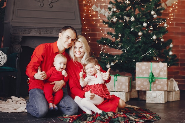 Family sitting at home near christmas tree