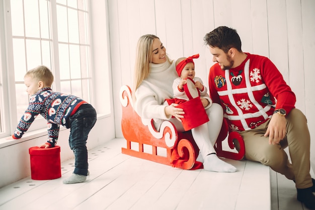 Family sitting at home with christmas gifts