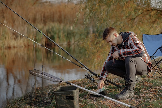 Family sitting near river in a fishing morning