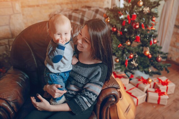 Family sitting on a sofa with dog at christmas