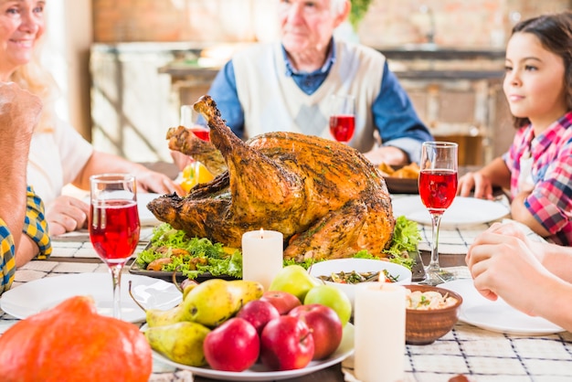 Free photo family sitting at table with backed ham