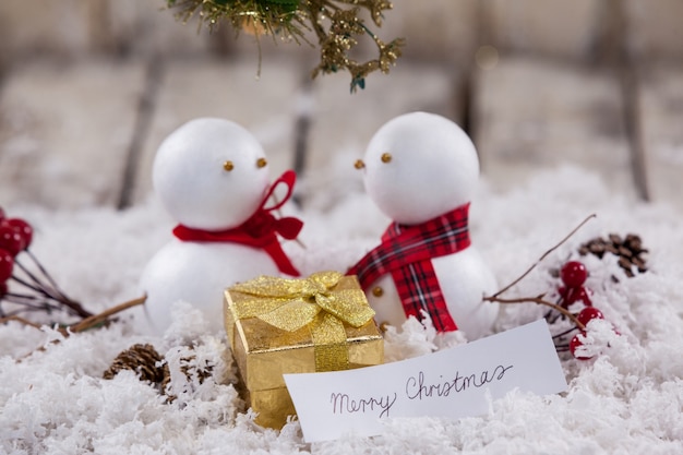 Family of snowmen with a message of merry christmas