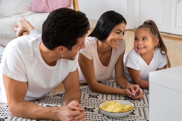 Free photo family spending time in front of tv