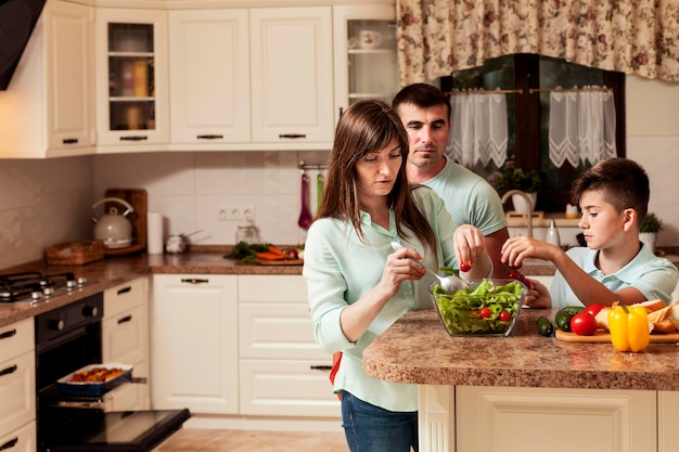 Family spending time together in the kitchen preparing food