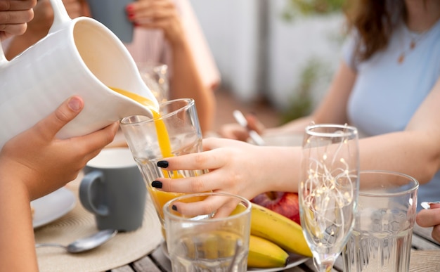 Family spending time together outdoors and drinking orange juice