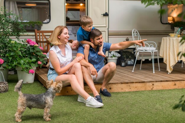 Family spending time together next to their caravan