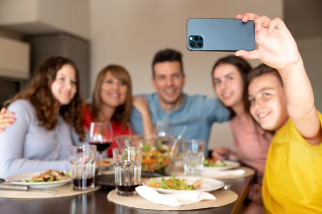 Family taking selfie together at dinner