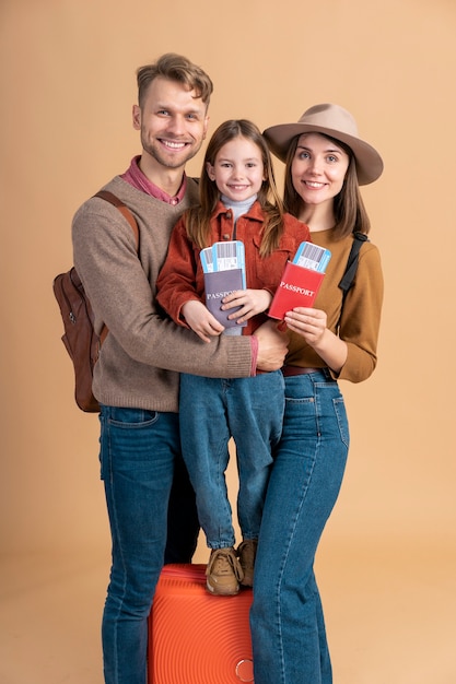 Free photo family of three ready for traveling with passport and plane tickets