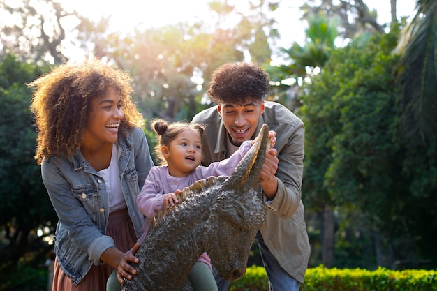 Free photo family of three spending time together outdoors on father's day