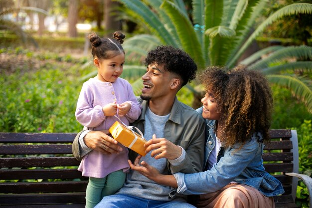 Family of three spending time together outdoors on father's day