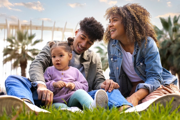 Free photo family of three spending time together outdoors on father's day