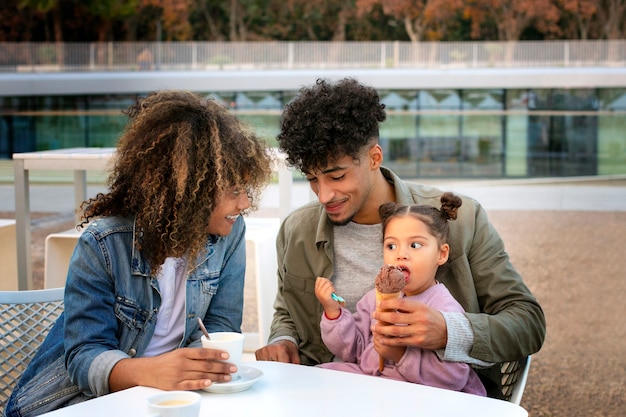 Free photo family of three spending time together outdoors on father's day