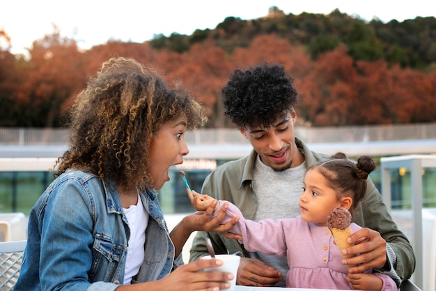 Free photo family of three spending time together outdoors on father's day