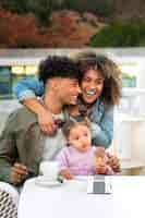 Free photo family of three spending time together outdoors on father's day