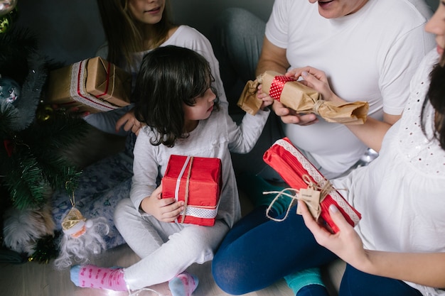 Family unwrapping gifts