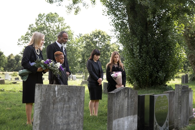 Free photo family visiting grave of loved one