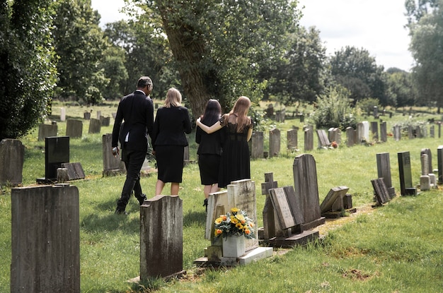 Free photo family visiting grave of loved one