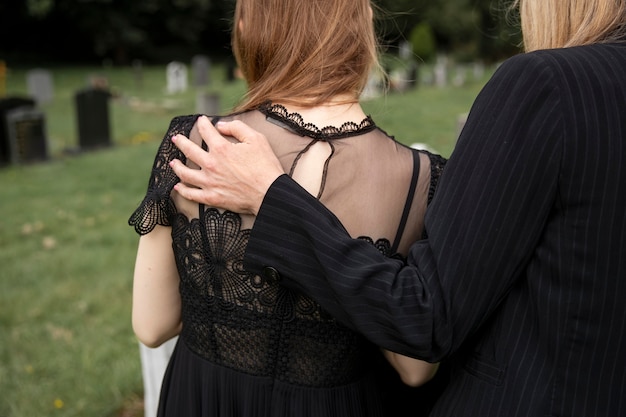 Free photo family visiting grave of loved one