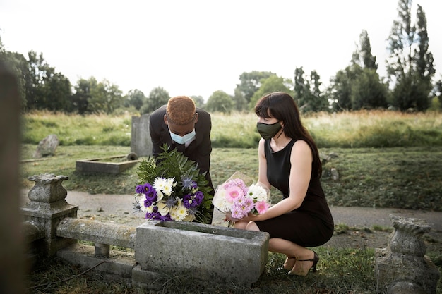 Family visiting grave of loved one