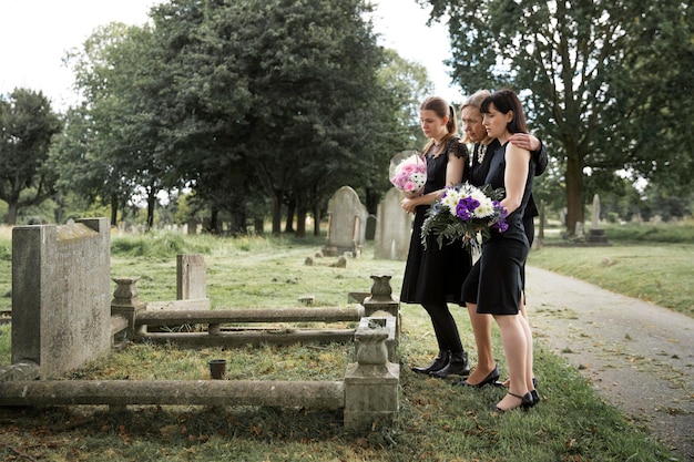 Free photo family visiting grave of loved one