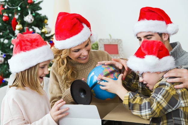 Family watching as a child opens a gift