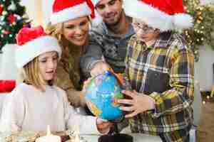 Free photo family watching as child watches his earth globe