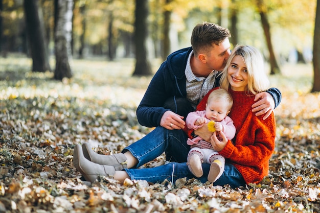 Family with baby daugher in an autumn park