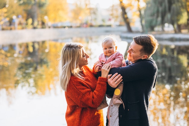 Family with baby daughter walking in park