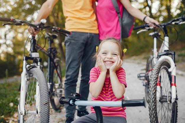 Family with a bicycle in a summer park