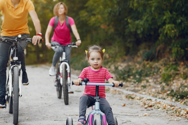 Family with a bicycle in a summer park