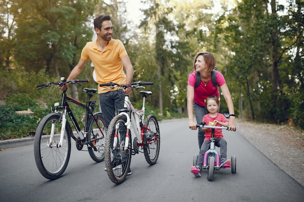 Family with a bicycle in a summer park