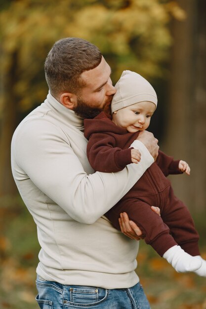 Family with cute daughter. Father in a bbrown sweater. Little girl with a dad.