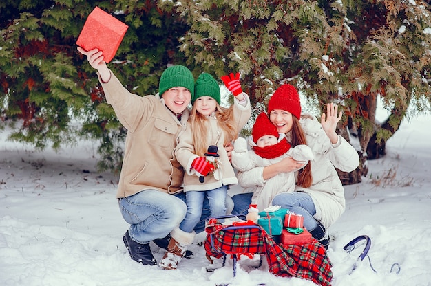 Free photo family with cute daughters in a winter park