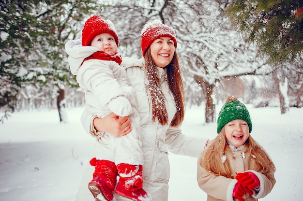 Family with cute daughters in a winter park