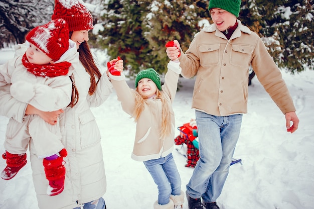 Free Photo family with cute daughters in a winter park