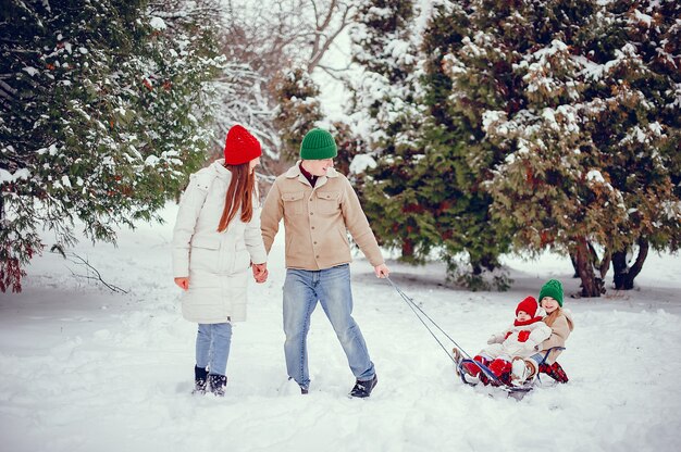 Family with cute daughters in a winter park